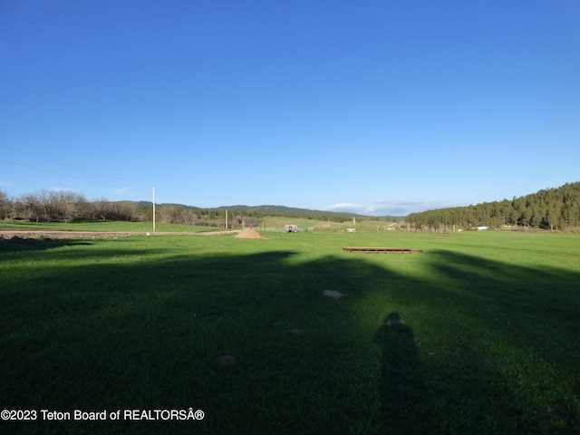 surrounding community featuring a lawn and a rural view