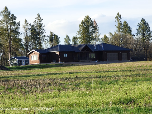 ranch-style house with a front yard and a garage