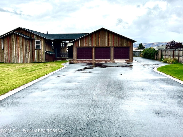 view of front facade with a front yard and a garage