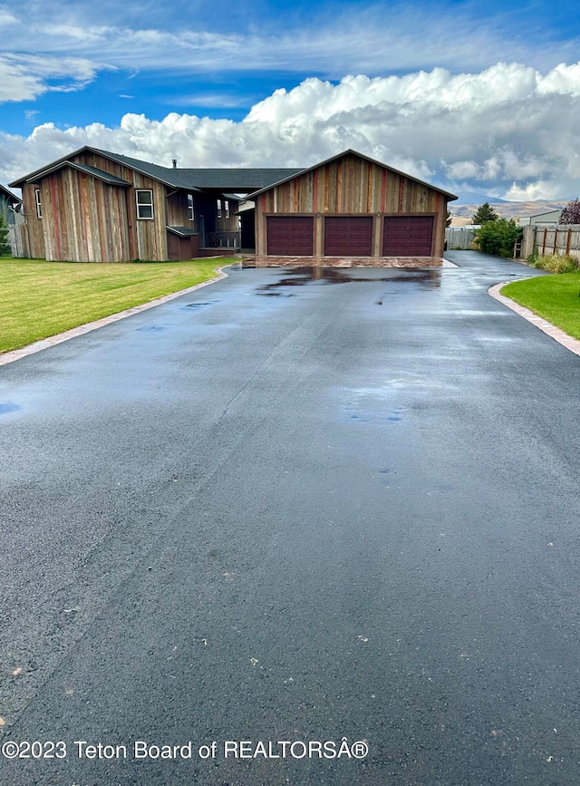 exterior space featuring a front lawn and a garage