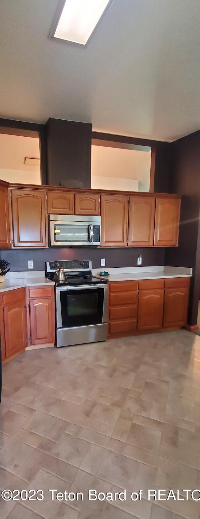 kitchen featuring appliances with stainless steel finishes and light tile flooring