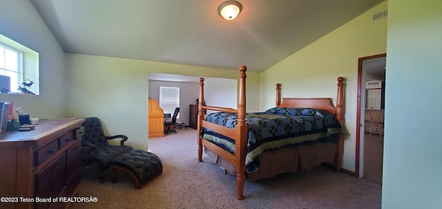 bedroom with carpet floors and lofted ceiling