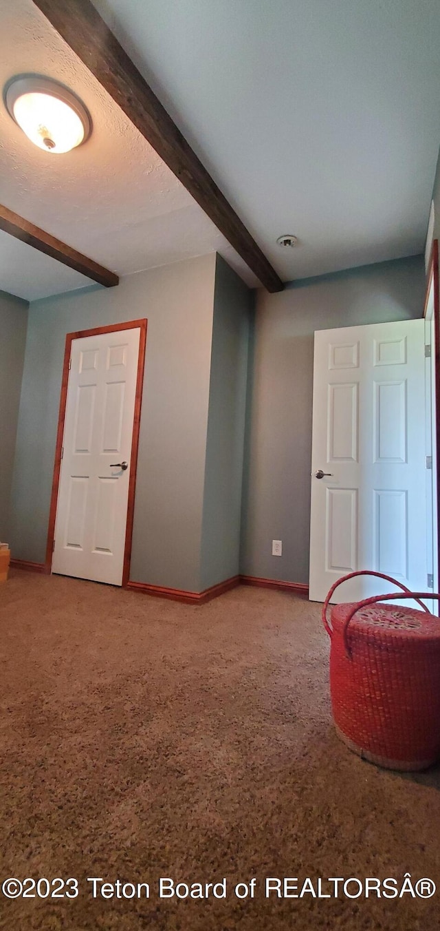 bedroom with carpet and beamed ceiling