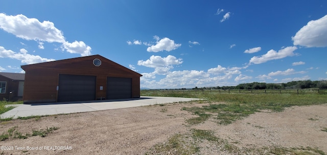 garage featuring a rural view