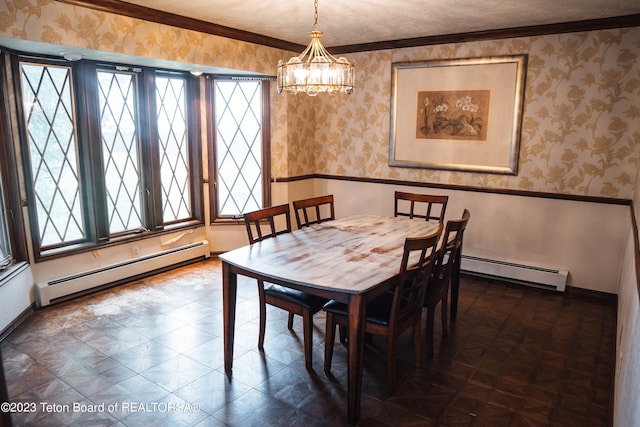 dining room featuring a notable chandelier, ornamental molding, and a baseboard heating unit