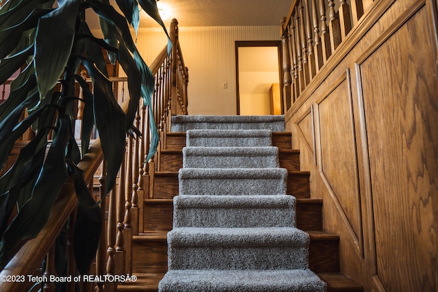 staircase with dark hardwood / wood-style floors