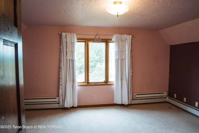 additional living space with light colored carpet, vaulted ceiling, a baseboard radiator, and a textured ceiling