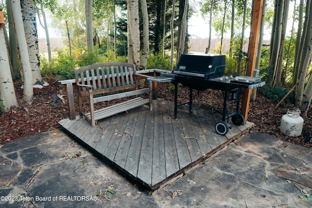 wooden terrace with a patio area