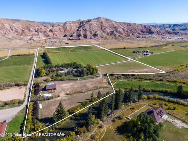 bird's eye view featuring a rural view and a mountain view