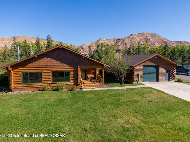 log home featuring a front lawn, a porch, a mountain view, and a garage