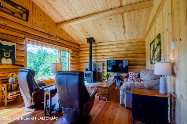 living room with dark hardwood / wood-style flooring, log walls, and a wood stove