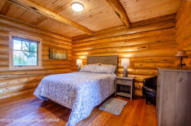 bedroom with beam ceiling, log walls, dark wood-type flooring, and wood ceiling