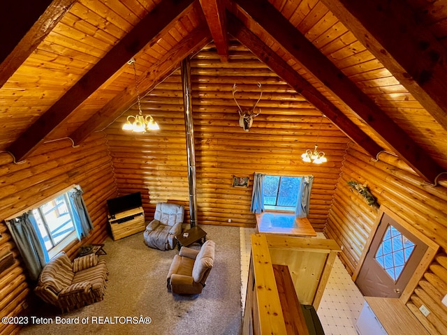 unfurnished living room with a chandelier, log walls, wooden ceiling, and beamed ceiling