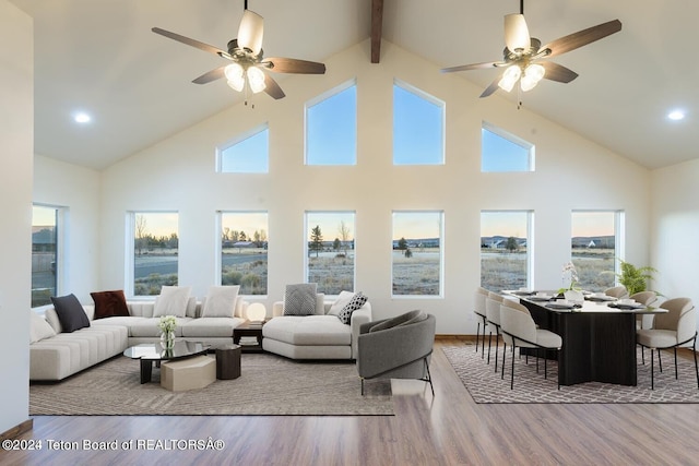 living room with high vaulted ceiling, hardwood / wood-style flooring, and ceiling fan