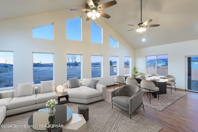 living room with high vaulted ceiling, ceiling fan, and hardwood / wood-style flooring