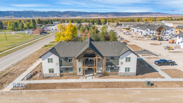 birds eye view of property with a mountain view