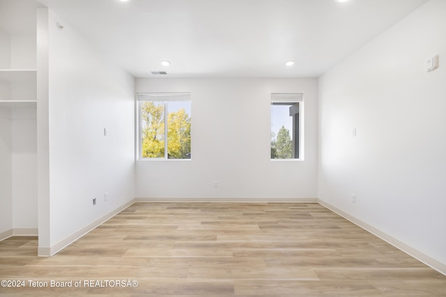 unfurnished room featuring light hardwood / wood-style floors