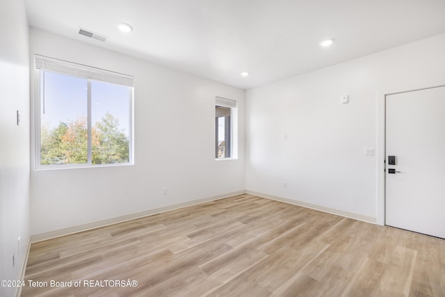 unfurnished room with light hardwood / wood-style flooring