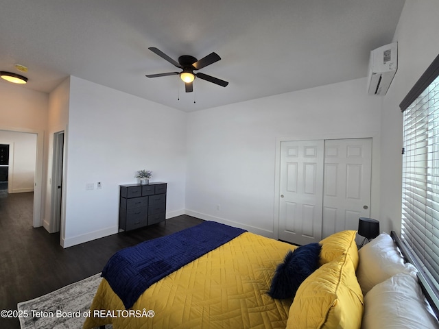 bedroom featuring baseboards, ceiling fan, dark wood-type flooring, an AC wall unit, and a closet