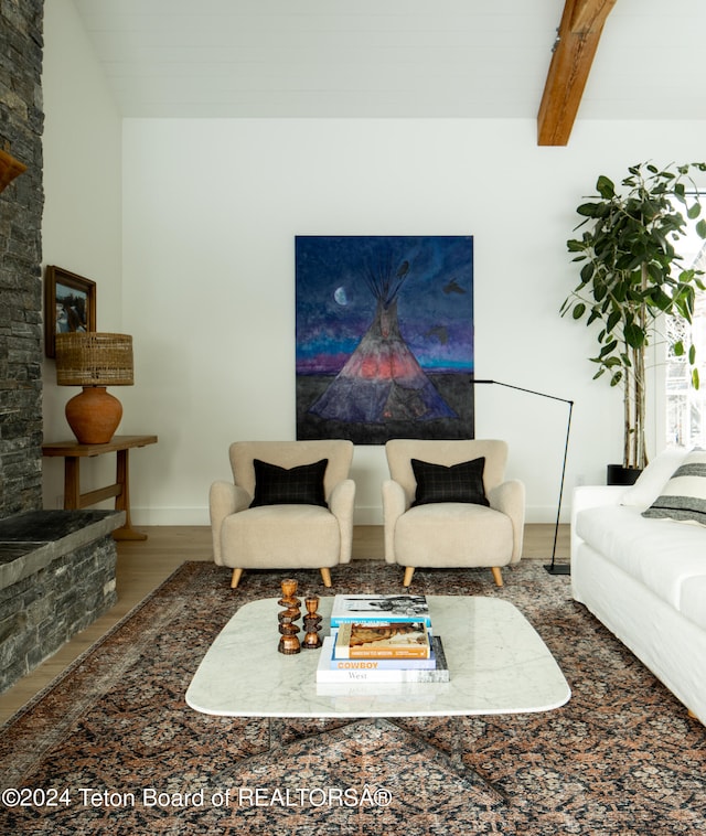 living room with beamed ceiling, hardwood / wood-style floors, and high vaulted ceiling