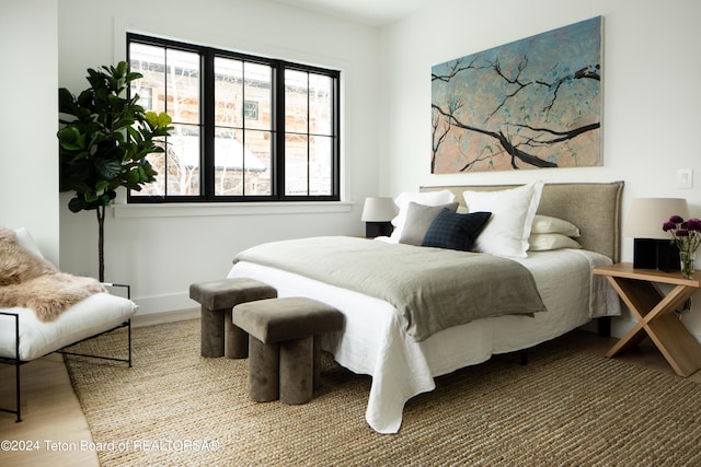 bedroom featuring wood-type flooring and multiple windows