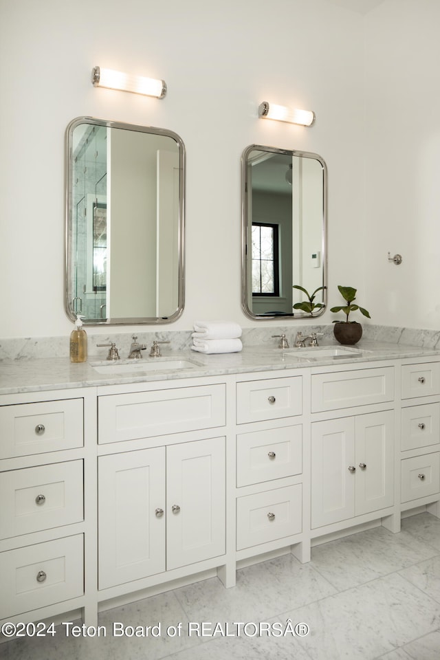 bathroom featuring double vanity and tile flooring