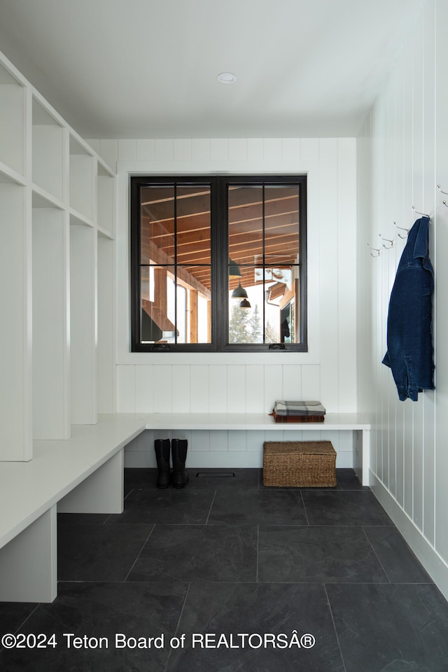 mudroom featuring dark tile flooring