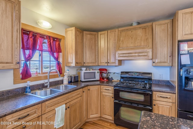 kitchen with sink, fridge with ice dispenser, light wood-type flooring, double oven range, and custom range hood