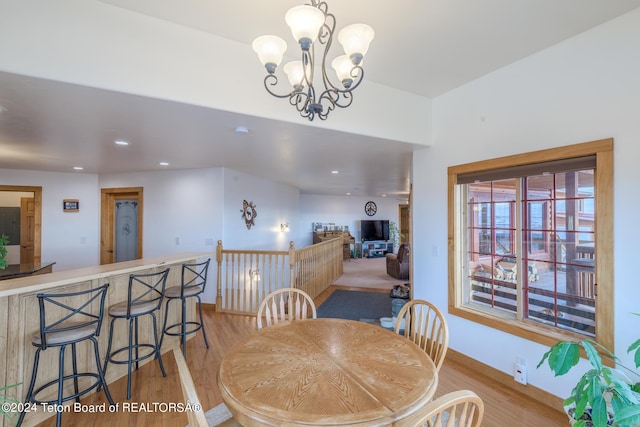 dining room with a chandelier and light wood-type flooring