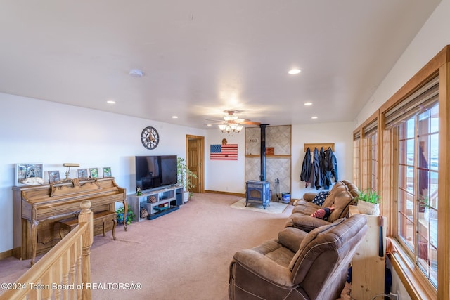 carpeted living room with a wood stove