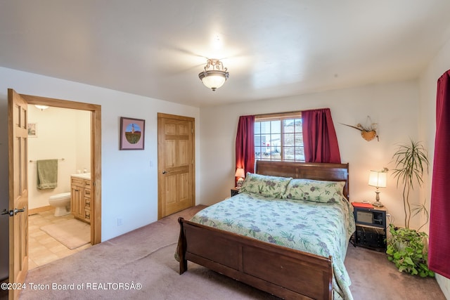 carpeted bedroom with connected bathroom