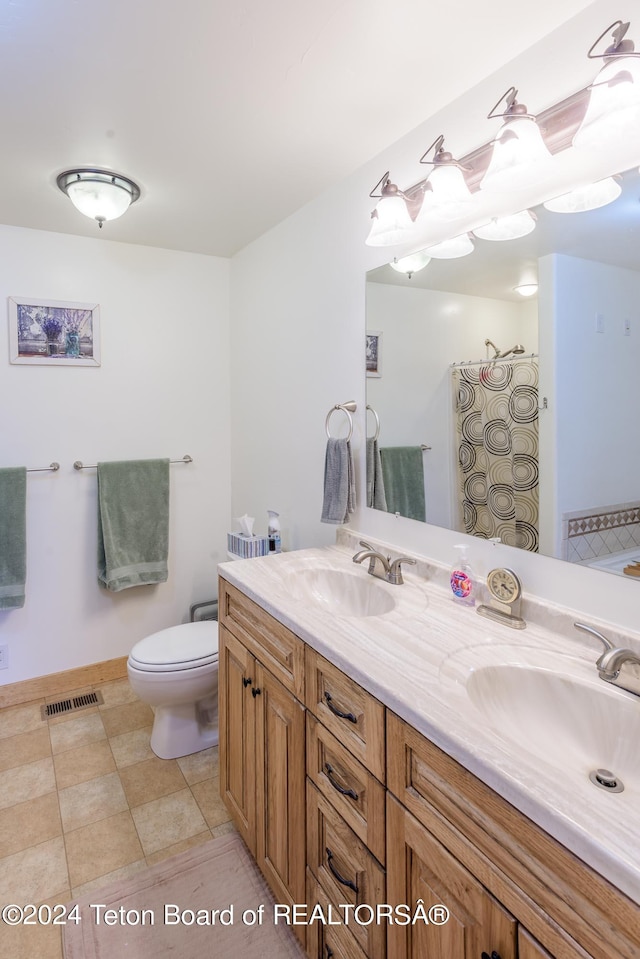 bathroom featuring vanity, a shower, and toilet