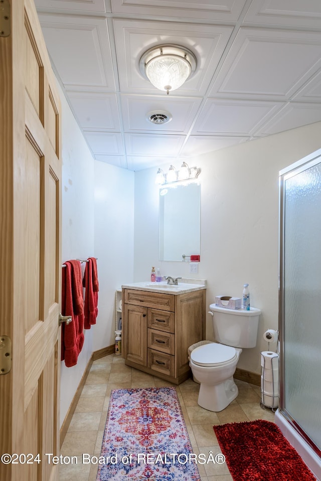 bathroom with vanity, tile patterned floors, toilet, and walk in shower