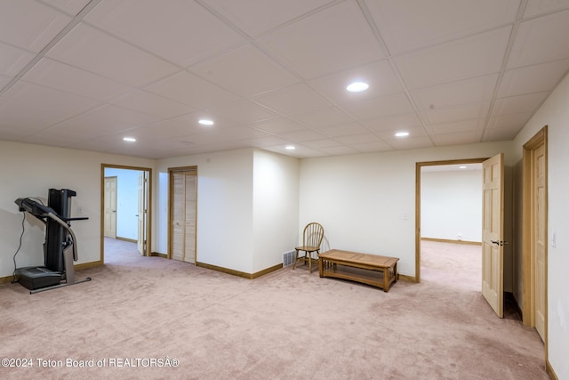 workout room featuring a drop ceiling and carpet floors