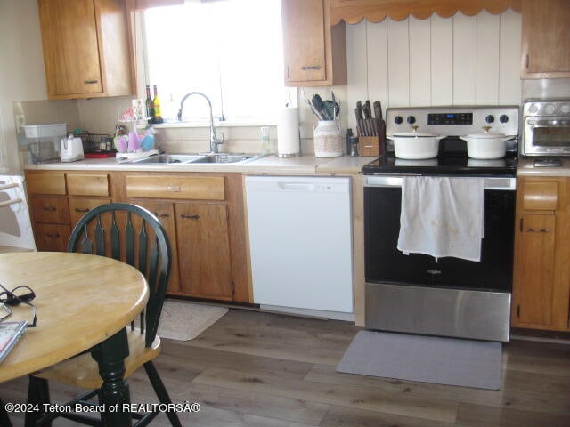 kitchen with sink, white appliances, and dark hardwood / wood-style flooring