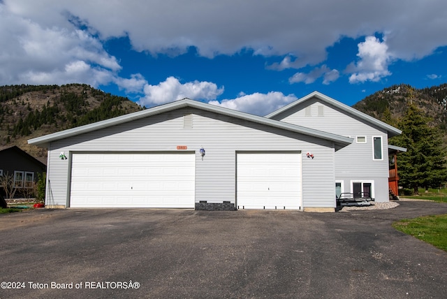 view of home's exterior featuring a garage and a mountain view