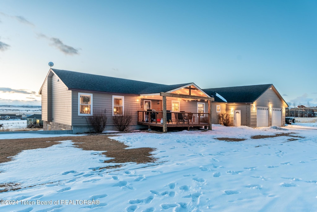 view of front of home with a deck and a garage