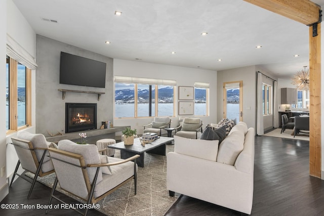 3139 Slinger Ct, Driggs, ID 83422 - living room featuring recessed lighting, wood finished floors, a glass covered fireplace, and baseboards