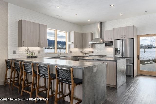 3139 Slinger Ct, Driggs, ID 83422 - kitchen featuring appliances with stainless steel finishes, wall chimney exhaust hood, modern cabinets, a peninsula, and recessed lighting