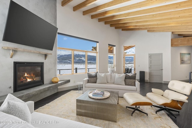 3139 Slinger Ct, Driggs, ID 83422 - living area with beamed ceiling, plenty of natural light, a fireplace, a high ceiling, and wood finished floors