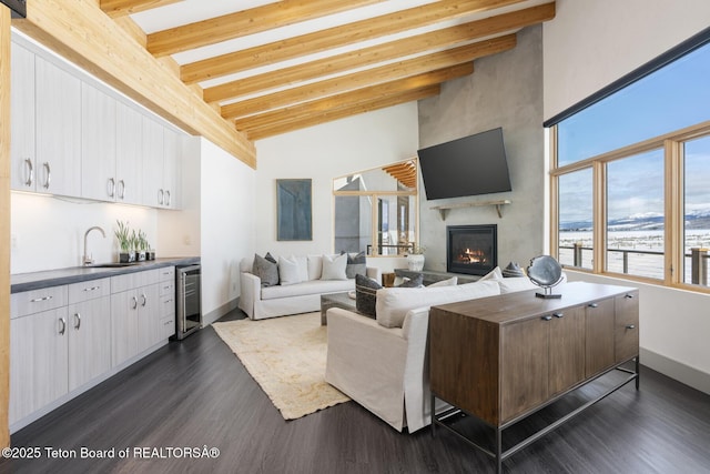 3139 Slinger Ct, Driggs, ID 83422 - living room with high vaulted ceiling, beam ceiling, wet bar, dark wood finished floors, and a fireplace