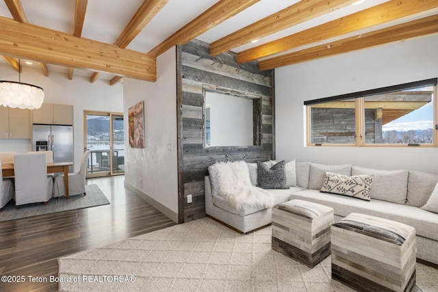 3139 Slinger Ct, Driggs, ID 83422 - living room featuring beamed ceiling, baseboards, and light wood-type flooring