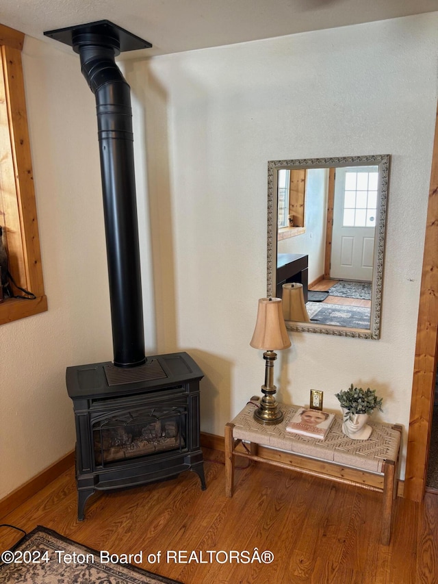 room details featuring wood-type flooring and a wood stove