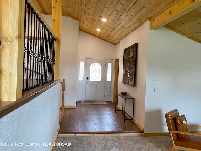 entrance foyer with lofted ceiling with beams, dark carpet, and wood ceiling