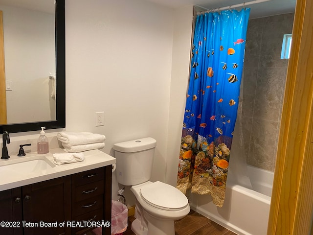 full bathroom featuring shower / bathtub combination with curtain, toilet, vanity, and hardwood / wood-style flooring