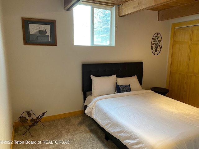 bedroom with carpet flooring and wood ceiling