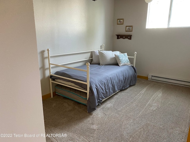 carpeted bedroom with a baseboard heating unit