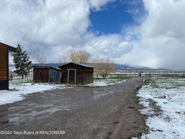 exterior space featuring a storage unit and a rural view