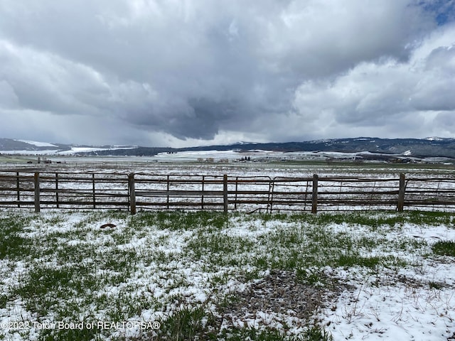 yard layered in snow featuring a rural view