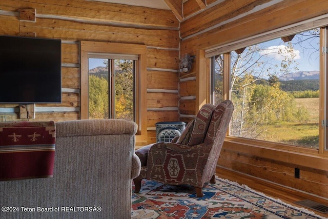 5 W Blair Rd, Alta, WY 83414 - interior space with log walls, a mountain view, and dark hardwood / wood-style flooring
